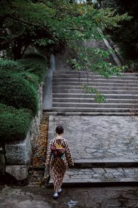 High angle view of woman walking on steps