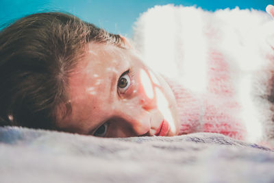 Portrait of woman lying on bed