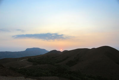 Scenic view of silhouette mountains against sky during sunset