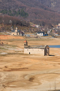 Built structure on field against mountain