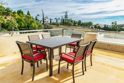 A dining table on a luxury terrace overlooking the mediterranean coastline