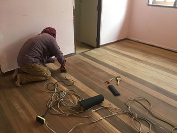 Worker working on wooden floor at home