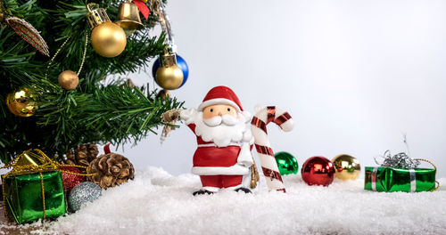 Close-up of christmas decorations against white background