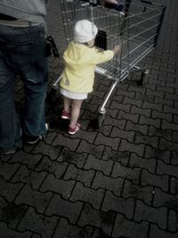 Woman standing on footpath