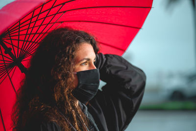 Portrait of young woman in rain