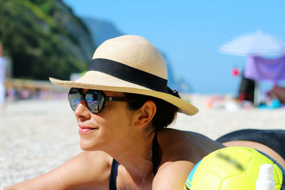 Portrait of mature man wearing sunglasses at beach