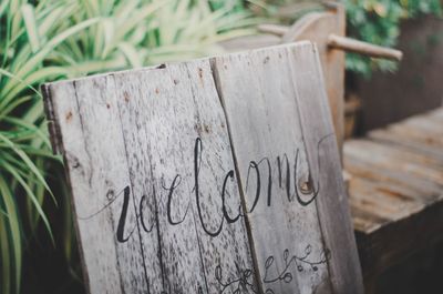 Close-up of welcome text on wooden board