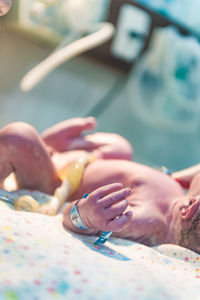 Close-up of baby lying in incubator