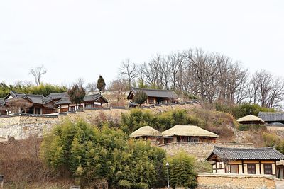 High angle view of houses and trees against clear sky