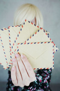 Close-up of envelopes held by woman