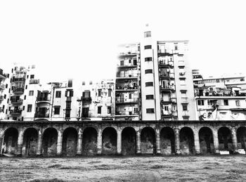 Buildings in city against clear sky