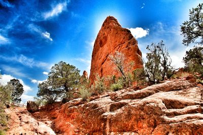 Low angle view of rock formations against blue sky