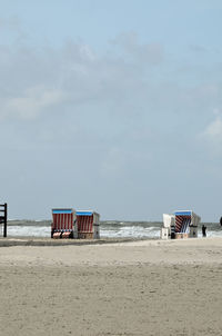 Lifeguard hut on beach against sky