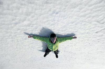 High angle view of man with arms outstretched