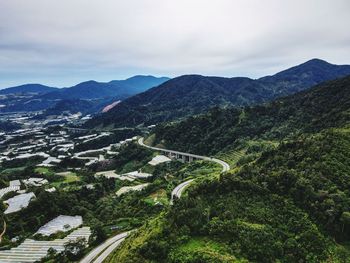 High angle view of green landscape against sky