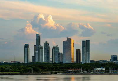 Buildings in city against sky during sunset