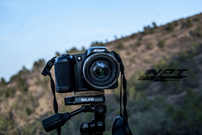 Close-up of camera against sky