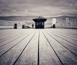 Wooden pier on sea against sky