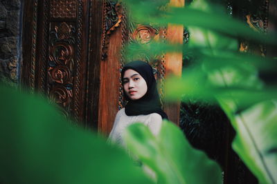 Portrait of woman against plants