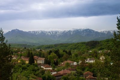 Houses on mountain against sky