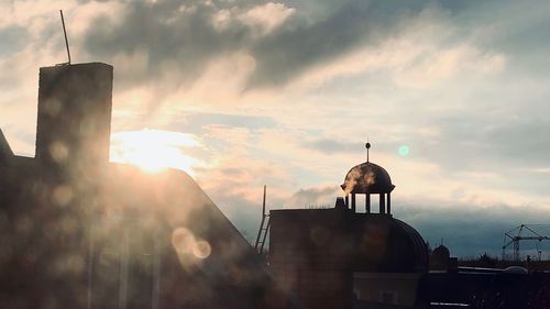 Traditional building against sky during sunset