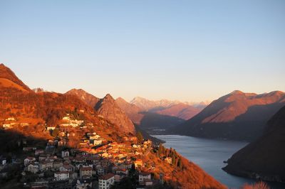 Scenic view of mountains and buildings against clear sky