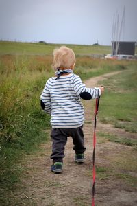 Rear view of boy on field