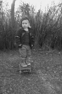 Full length of girl standing on tree trunk