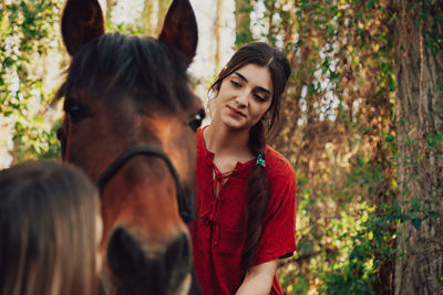 Portrait of woman sitting on horse