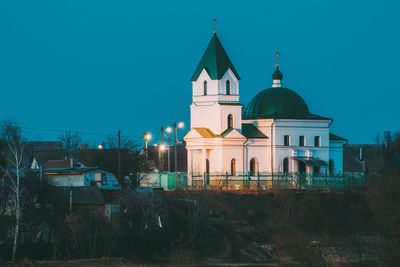 Illuminated building against sky