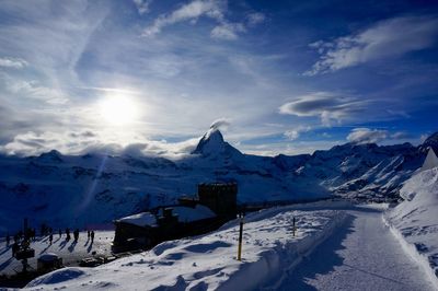 Scenic view of snow covered mountains against sky