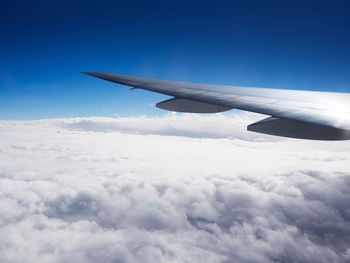 Aerial view of cloudscape over airplane wing