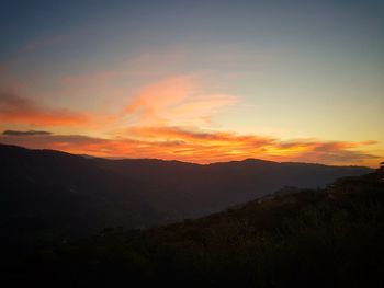 Scenic view of silhouette mountains against sky during sunset