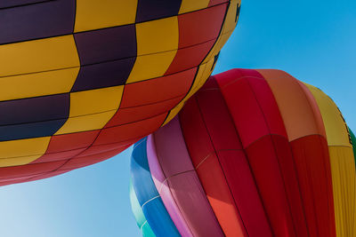 Low angle view of hot air balloons against blue sky