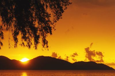 Scenic view of sea against orange sky