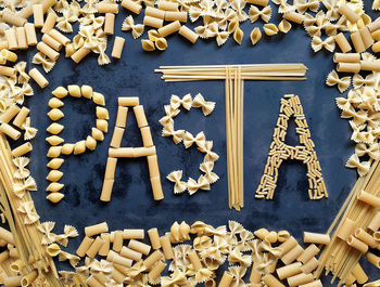 Pasta, word made with food on black table