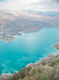 Aerial view of sea and mountains against sky