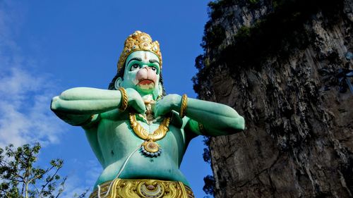 Low angle view of statue against blue sky