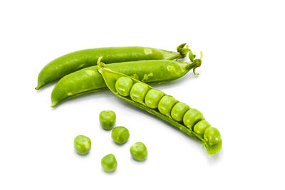 Close-up of green chili pepper against white background