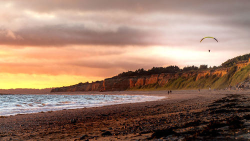 Scenic view of beach against sky during sunset