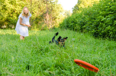 Woman with dog on grass