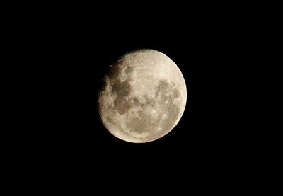 Low angle view of moon against clear sky at night