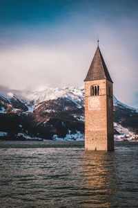 Church by building against sky