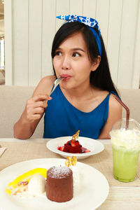 Woman eating dessert at restaurant