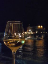 Close-up of wine glass on table at night