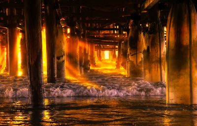 Scenic view of illuminated sea at night