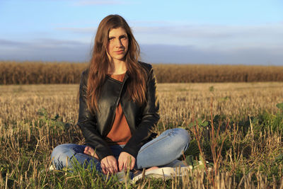 Young woman sitting on field