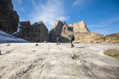 Roped climbing team approach mount asgard, baffin island.