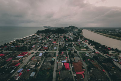 High angle view of buildings and sea against sky
