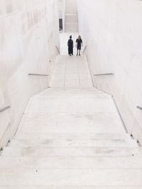 High angle view of people walking on staircase
